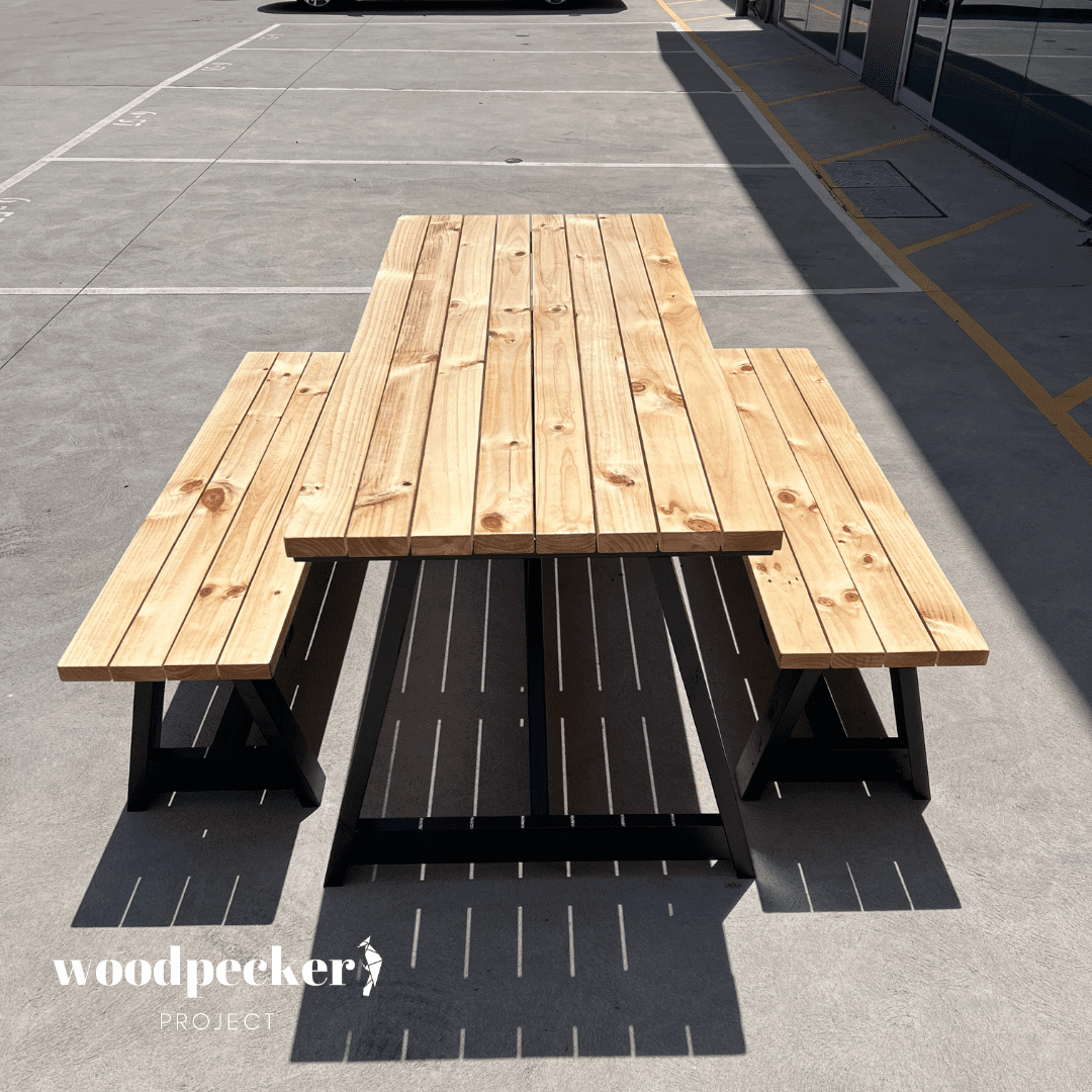 Modern outdoor table set with teak wood accents and contemporary design, offering a blend of natural beauty and modern style