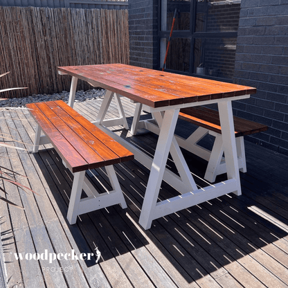 Modern outdoor dining set featuring synthetic rattan chairs and a sleek table, providing a stylish and comfortable dining area