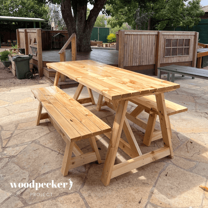 Modern outdoor table set with a tempered glass top and sturdy metal frame, providing a chic and durable dining solution